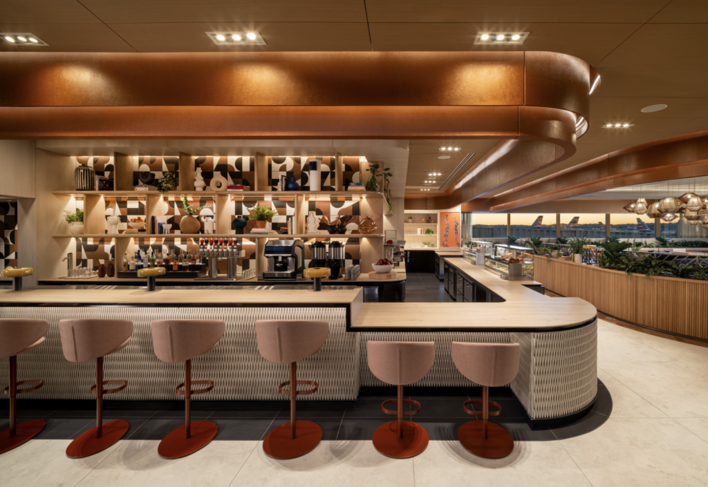 a bar with chairs and shelves in a restaurant